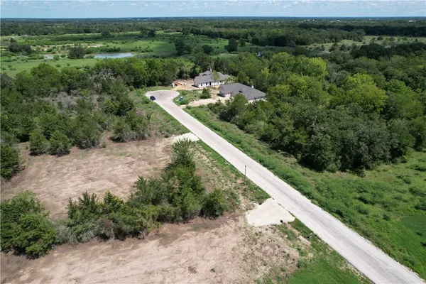 a view of a forest with a yard