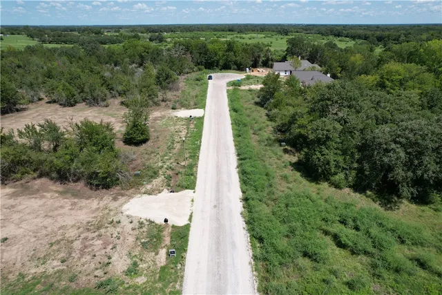 a view of a yard with large trees
