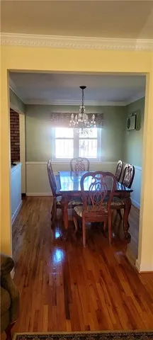 a view of livingroom with furniture chandelier and wooden floor