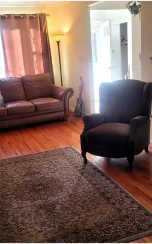 a living room with furniture and a rug