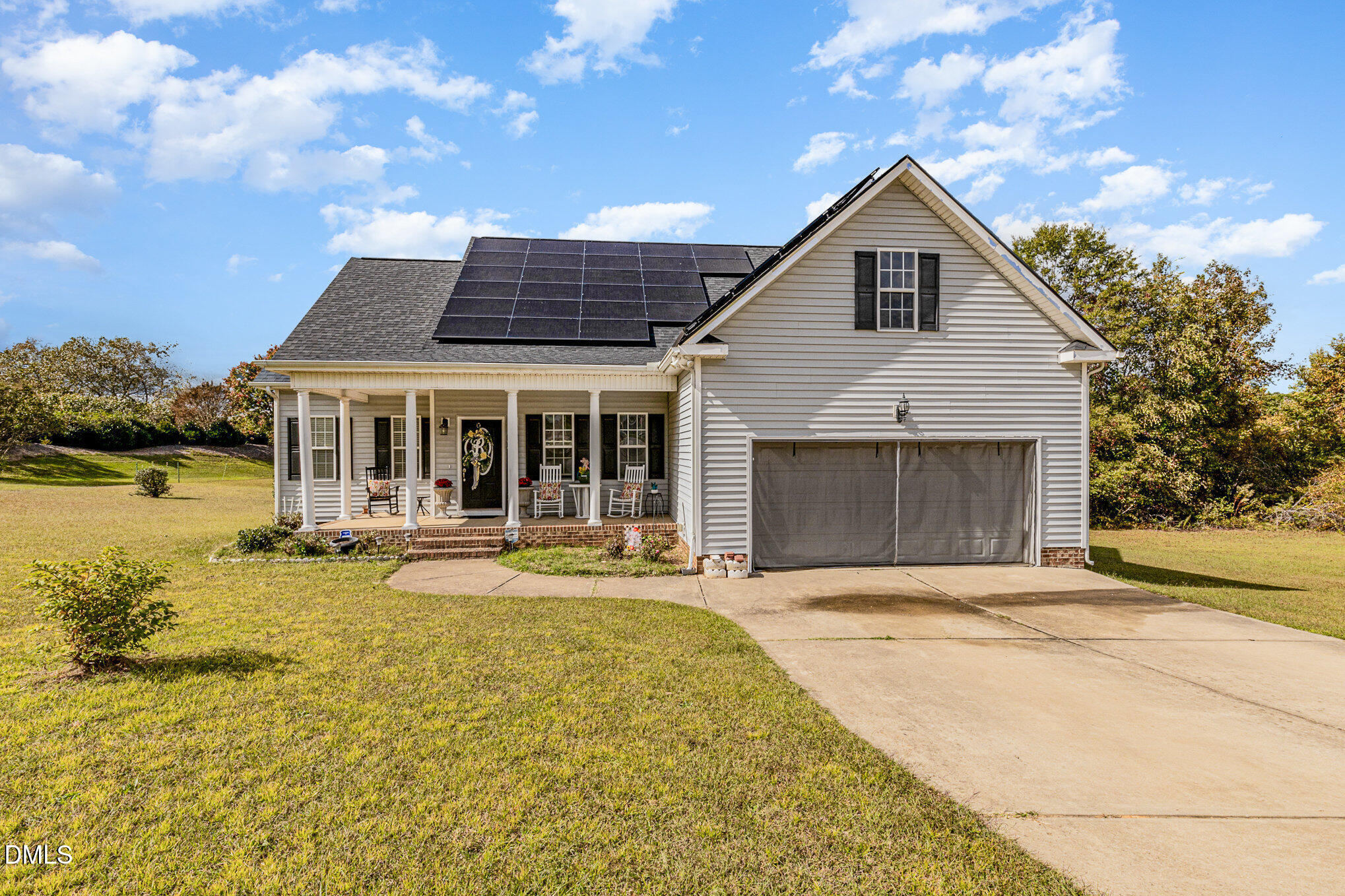 a view of a house with swimming pool and a yard