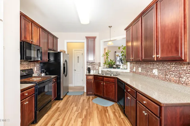 a view of a dining room with furniture wooden floor and chandelier