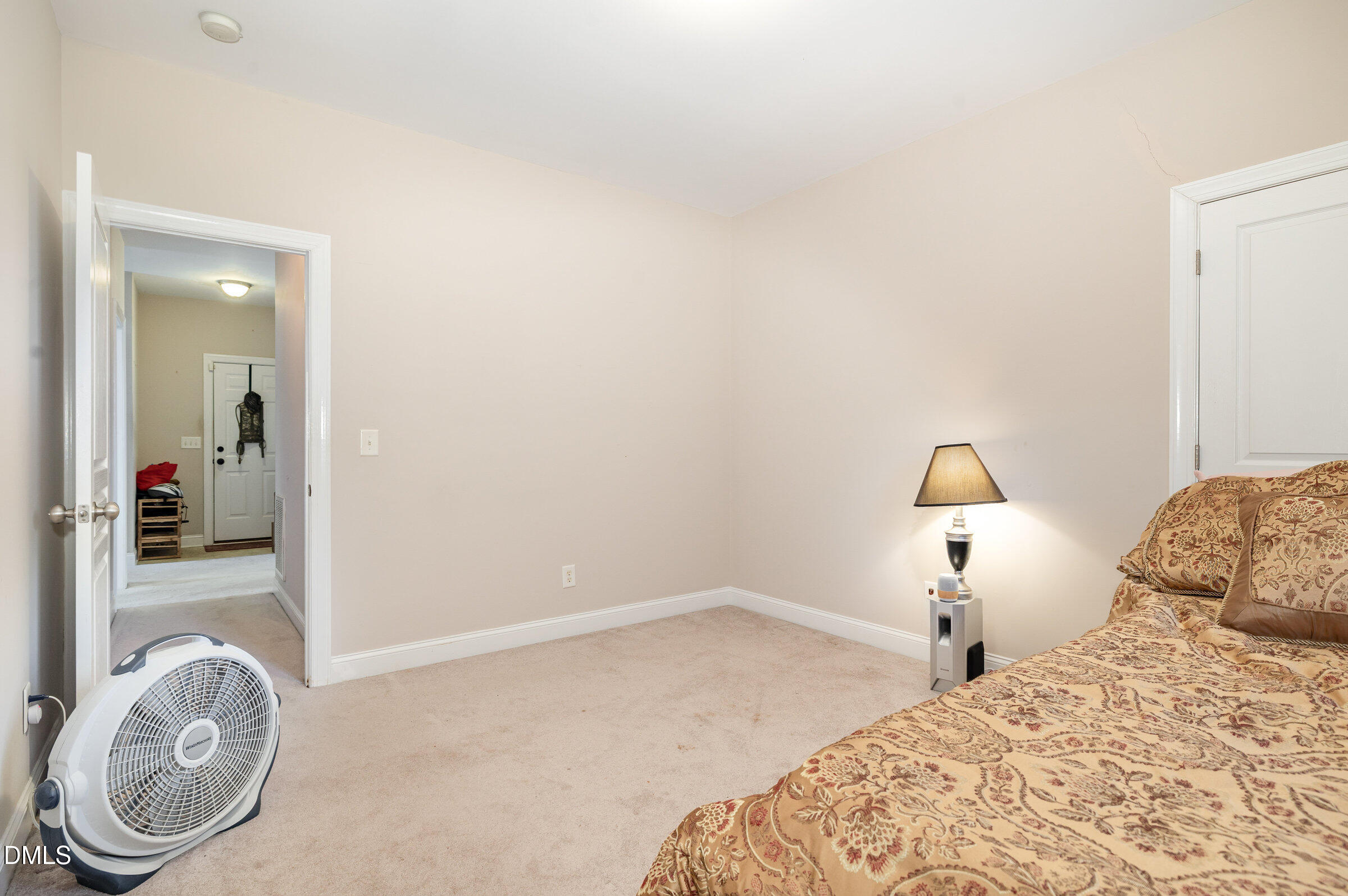 7300 Singlepond Lane Willow Spring, NC 27592 - Photo 19 of 34 a bedroom with a bed and a mirror