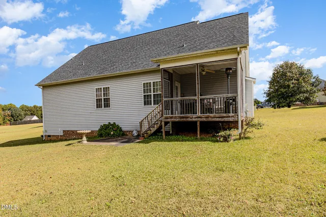a view of a house with swimming pool and sitting area