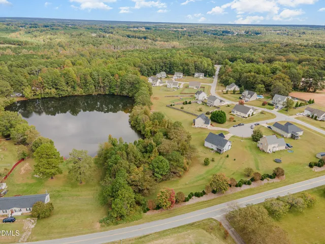 an aerial view of a house with a lake view