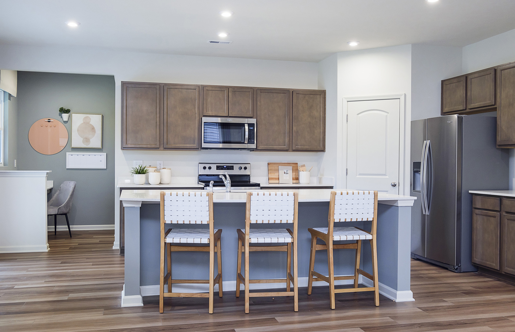 966 Houston Street Batavia, IL 60510 - Photo 7 of 20 a kitchen with a dining table chairs refrigerator and microwave