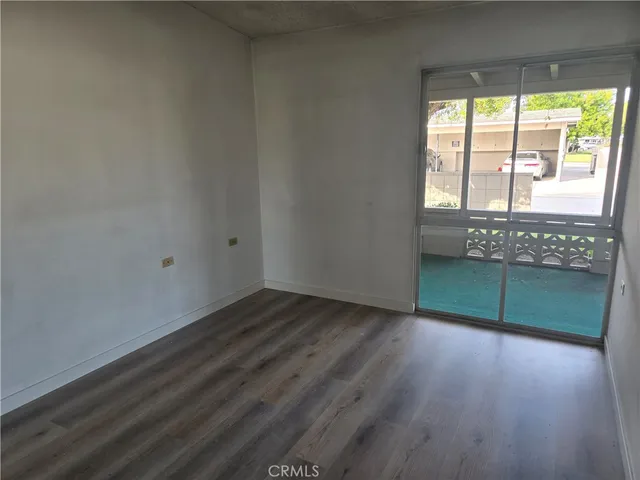a view of wooden floor and windows in a room