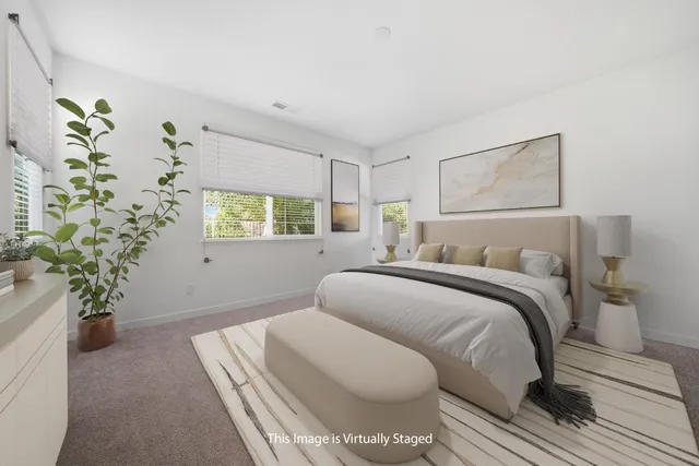 a bed sitting in a bedroom next to a window