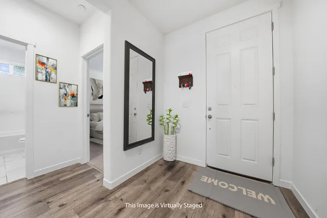 a bedroom with a bed and a painting on the wall