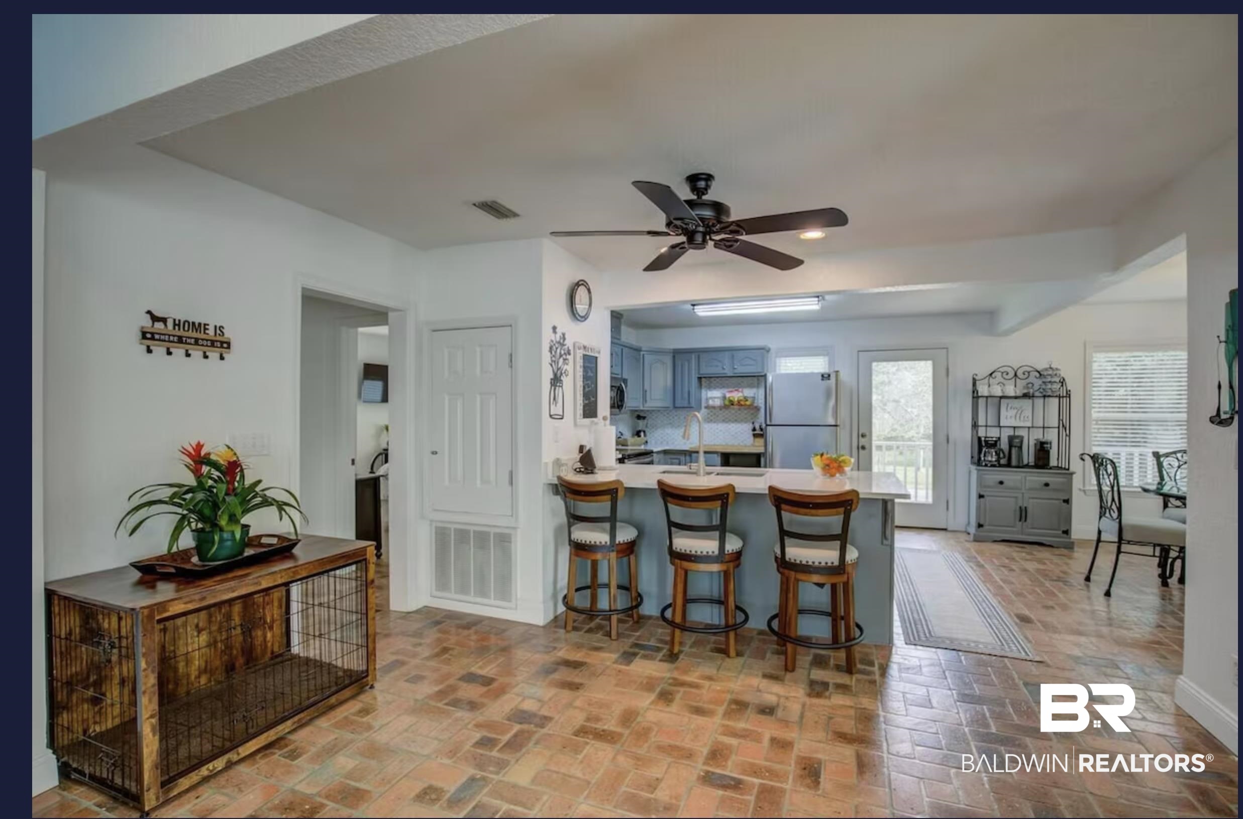 16297 Honey Road Summerdale, AL 36580 - Photo 12 of 24 Spacious open-concept living area featuring terracotta tile flooring, a kitchen island with seating, pendant lighting, and a ceiling fan
