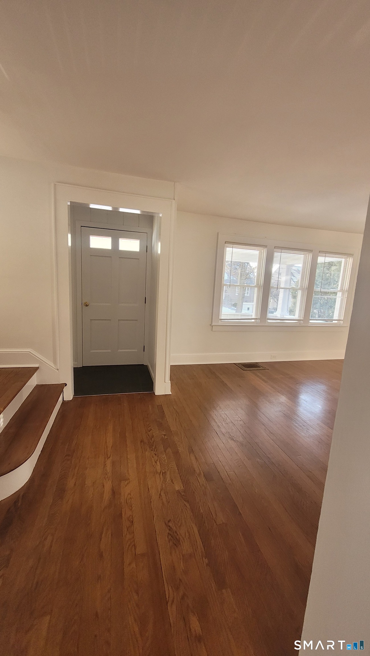 10 Olmstead Place Norwalk, CT 06855 - Photo 11 of 18 an empty room with wooden floor and windows