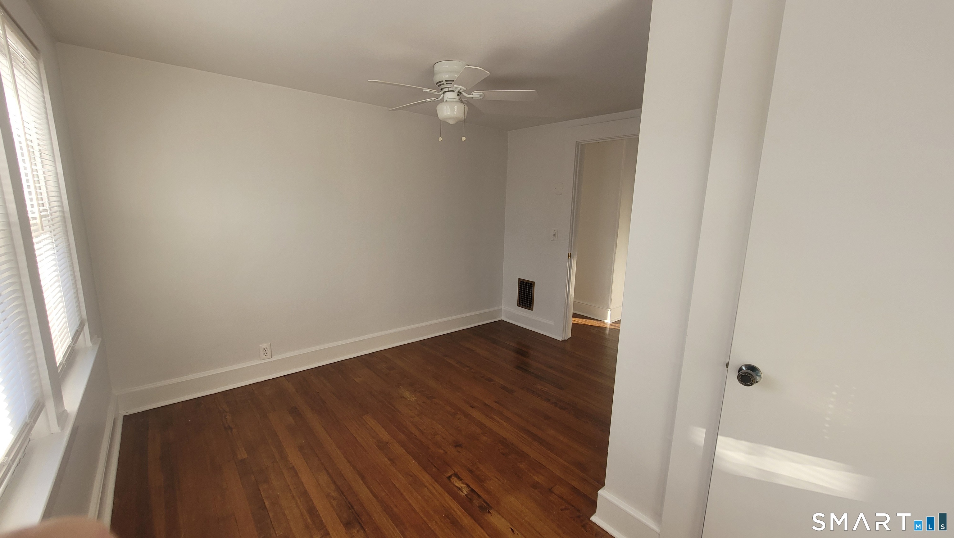 10 Olmstead Place Norwalk, CT 06855 - Photo 16 of 18 an empty room with wooden floor and fan