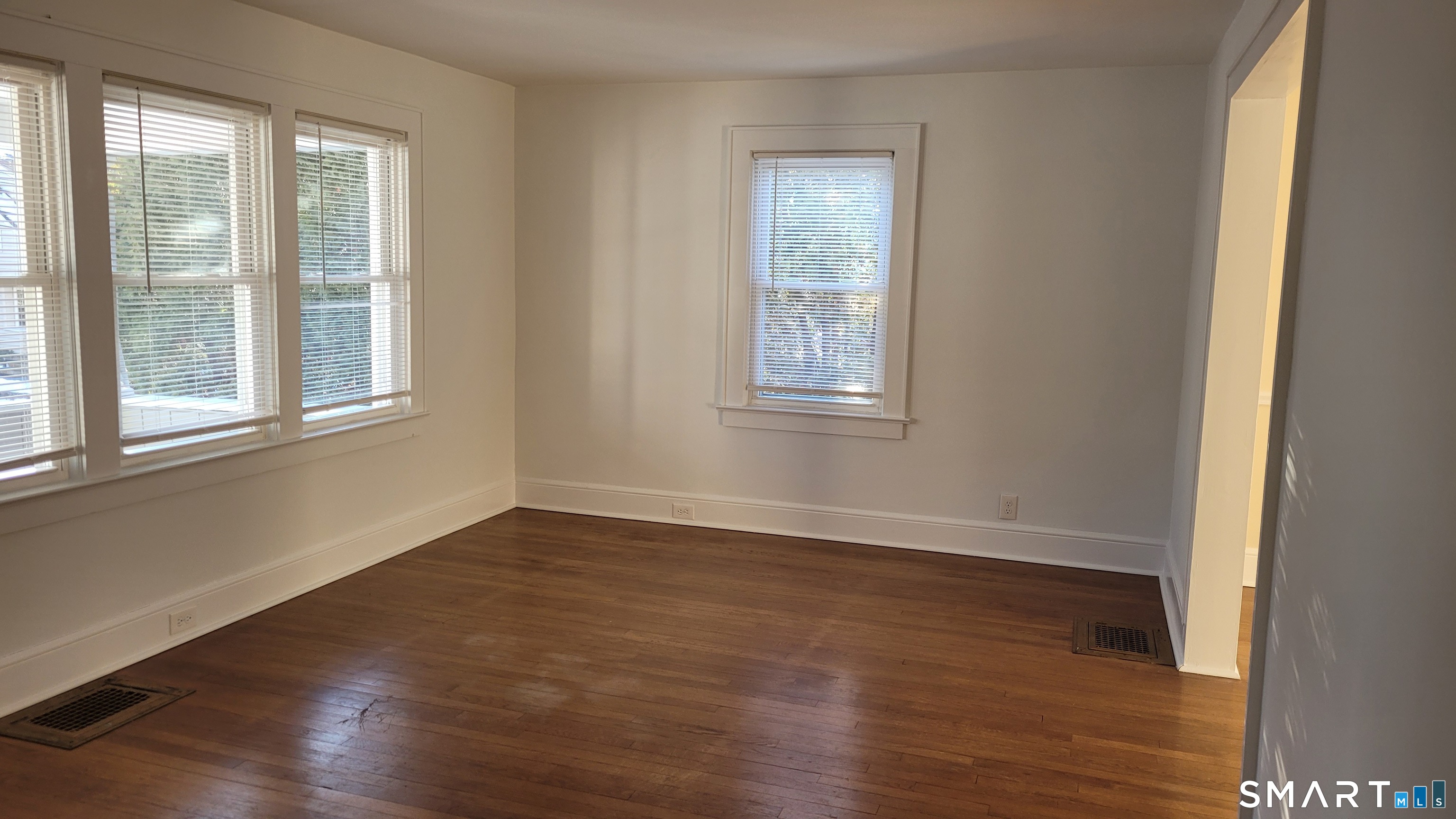 10 Olmstead Place Norwalk, CT 06855 - Photo 5 of 18 an empty room with wooden floor and windows