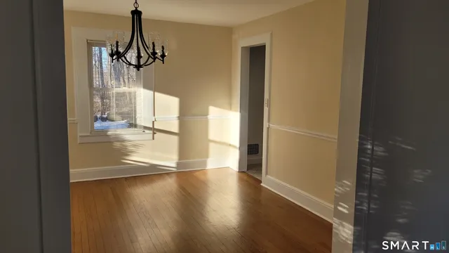 a view of a room with wooden floor