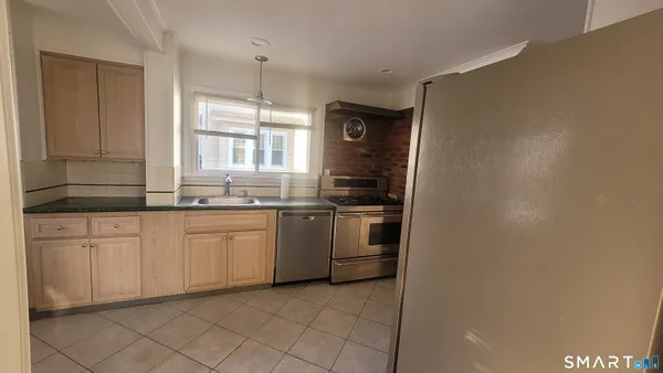 a kitchen with a sink cabinets and window