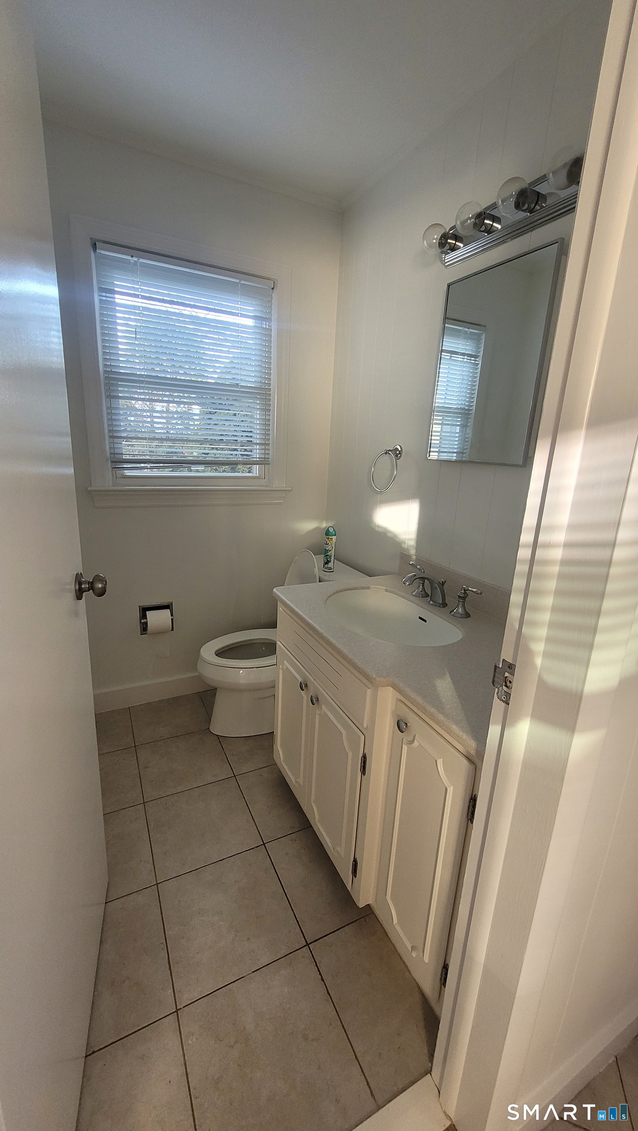 10 Olmstead Place Norwalk, CT 06855 - Photo 10 of 18 a spacious bathroom with a granite countertop sink a toilet and mirror