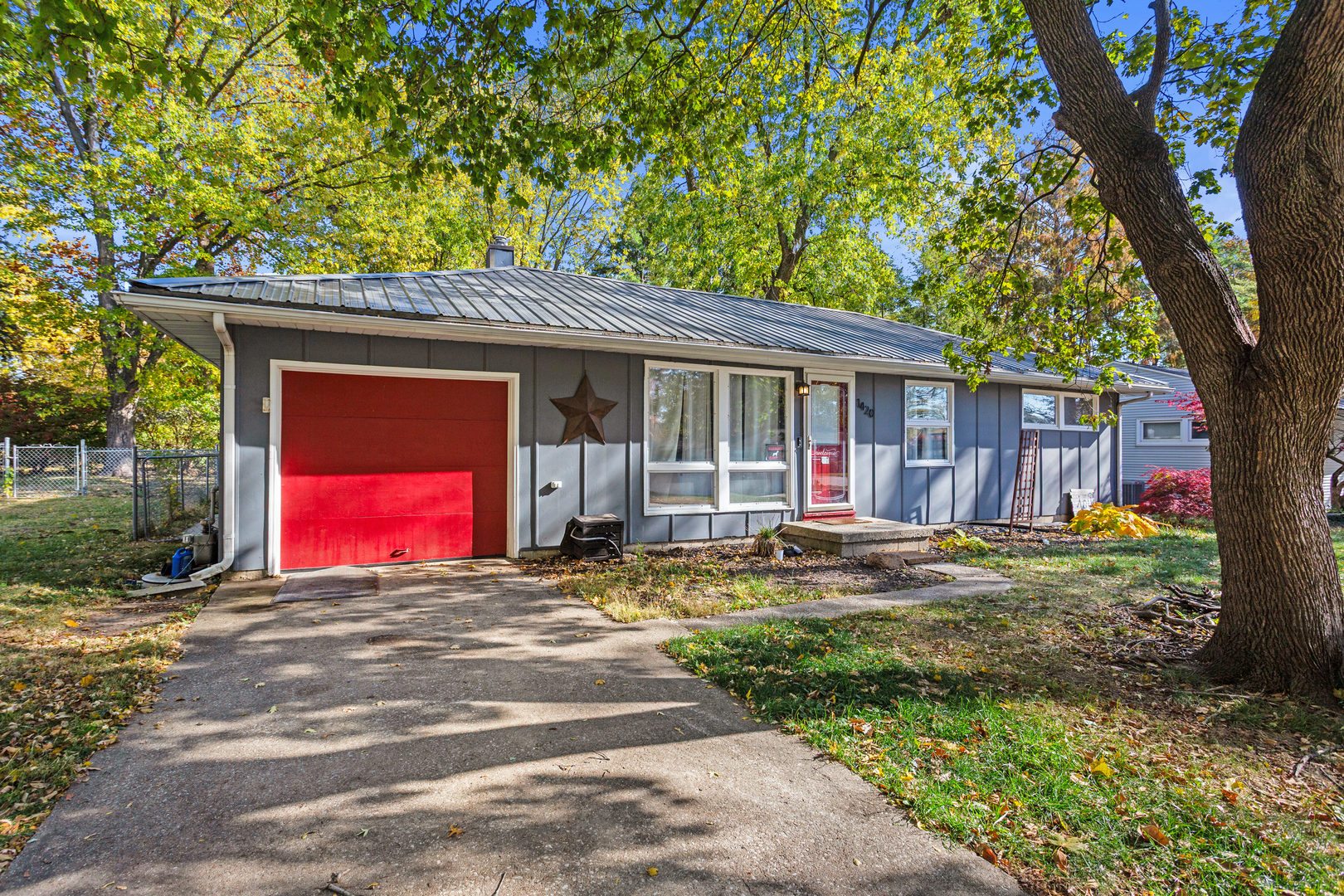 a view of a house with yard and tree s