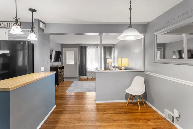 a living room with kitchen island furniture and a chandelier