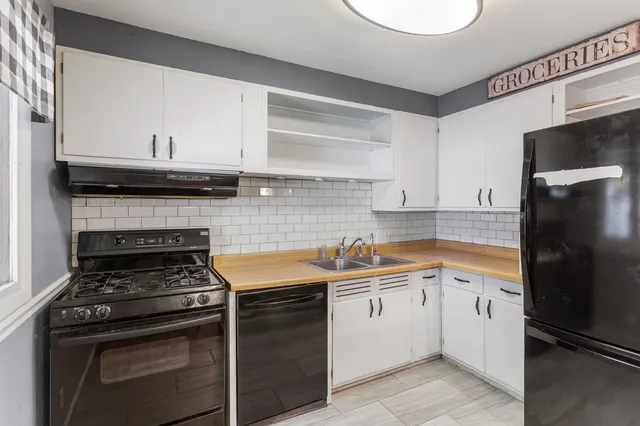 a kitchen with a stove and a refrigerator