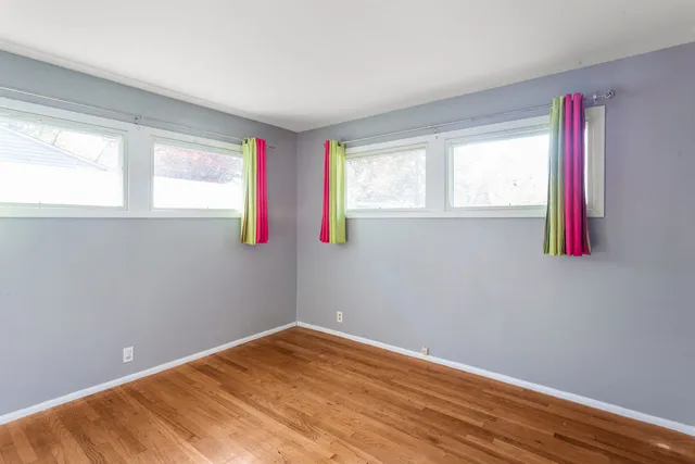a room with a window and a wooden floor