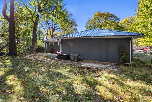 a backyard of a house with table and chairs