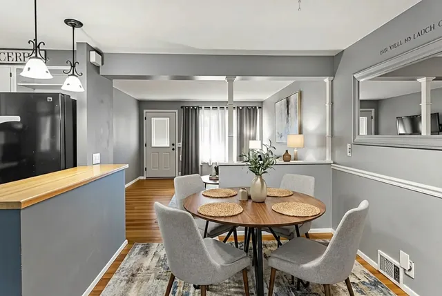 a view of a dining room with furniture and wooden floor