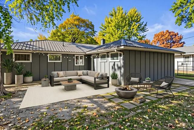 a view of a patio with couches table and chairs and potted plants