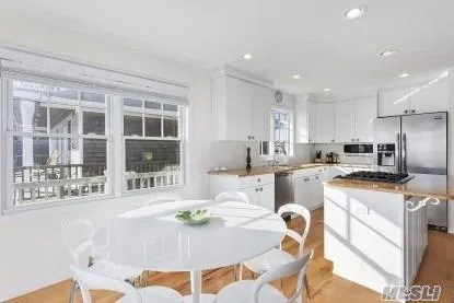 a kitchen with granite countertop a sink and white appliances
