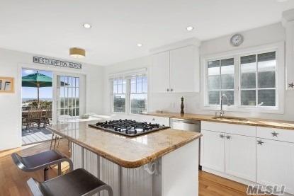 929 Dune Road West Hampton Dunes, NY 11978 - Photo 5 of 10 a kitchen with a stove a sink and cabinets