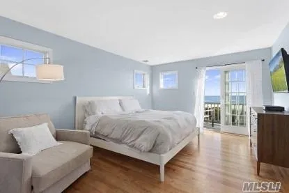 a bedroom with a bed and large window
