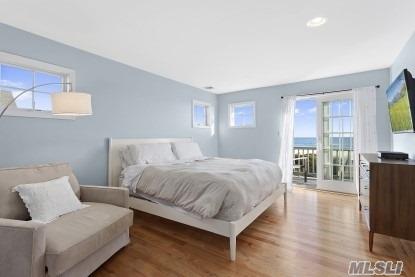 929 Dune Road West Hampton Dunes, NY 11978 - Photo 6 of 10 a bedroom with a bed and large window