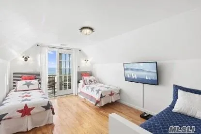 a bedroom with bed and wooden floor