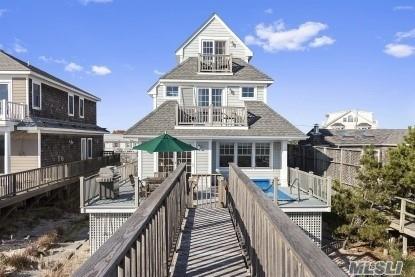 929 Dune Road West Hampton Dunes, NY 11978 - Photo 10 of 10 a front view of a house with a yard