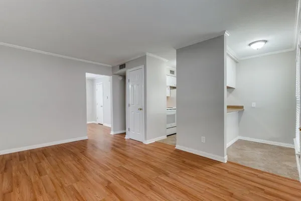 a view of wooden floor and windows in a room