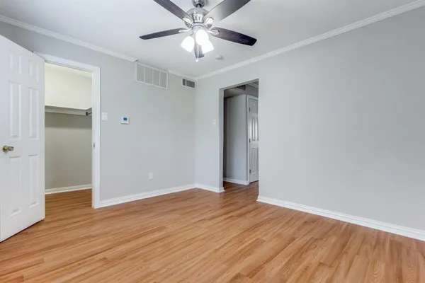 a view of an empty room with wooden floor