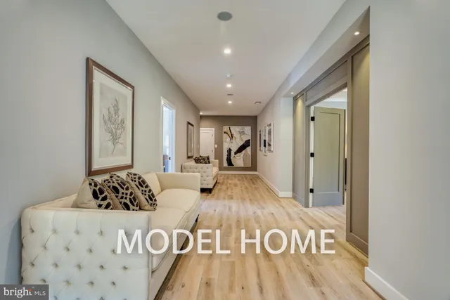 a view of hallway with furniture and windows