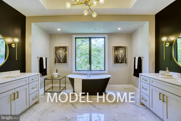 a spacious bathroom with a mirror a sink and a mirror