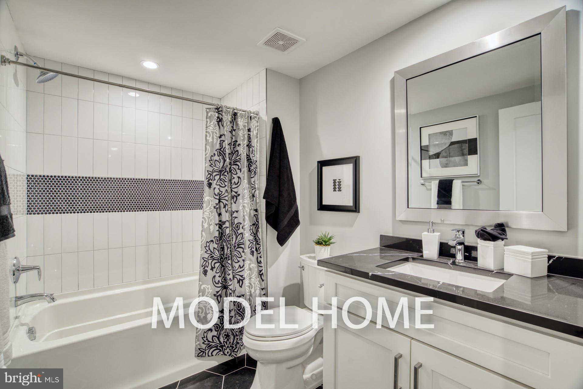 301 Nutley Street Southwest Vienna, VA 22180 - Photo 40 of 48 a bathroom with a granite countertop sink a toilet and a bathtub