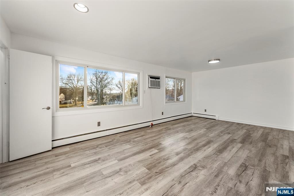 1 Dunn Road West Orange, NJ 07052 - Photo 7 of 20 an empty room with wooden floor and windows