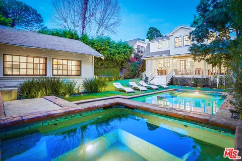 a front view of a house with a garden