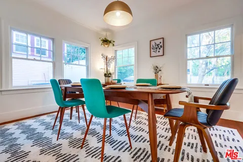 a view of a hallway with wooden floor and stairs