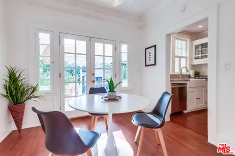 a view of a livingroom with furniture a bedroom and wooden floor