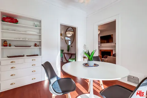 a bedroom with bed and a flat tv screen on dresser