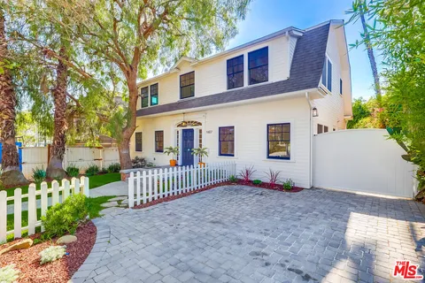 a living room with furniture and a book shelf