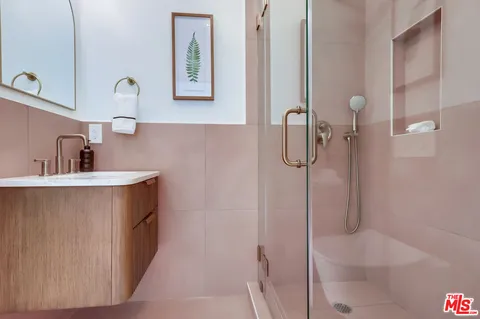 a bathroom with a sink a mirror and toilet