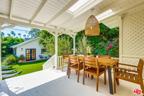 a spacious bedroom with a bed and wooden floor