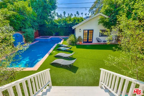 a bedroom with a dresser and a window