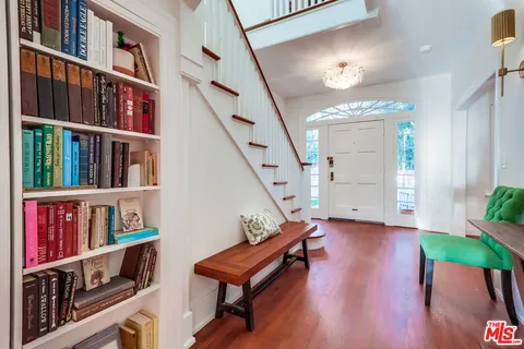 a living room with furniture a large window and a fireplace