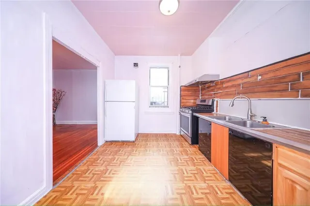 a large kitchen with a stove and a refrigerator