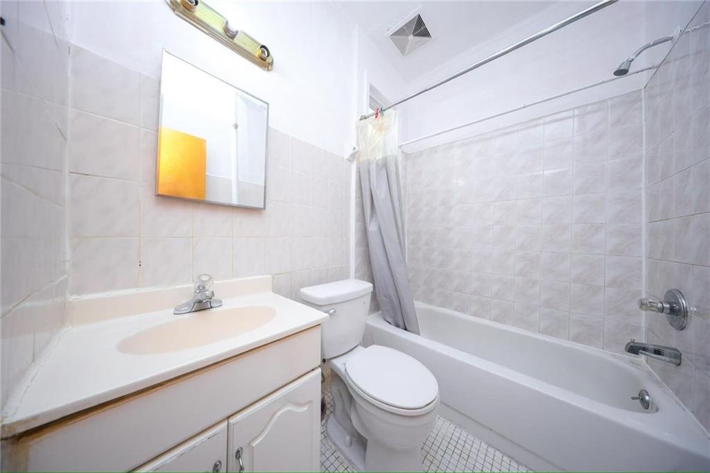 3617 Quentin Road Brooklyn, NY 11234 - Photo 13 of 16 a bathroom with a sink and a bathtub
